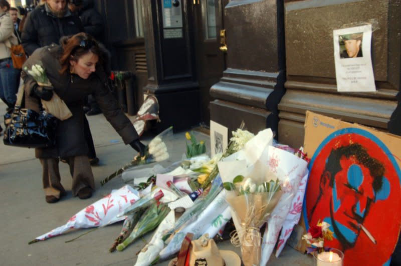 Pedestrians drop off flowers at the makeshift memorial outside the apartment building where 28-year-old actor Heath Ledger died in New York on January 22, 2008. File Photo by Ezio Petersen/UPI