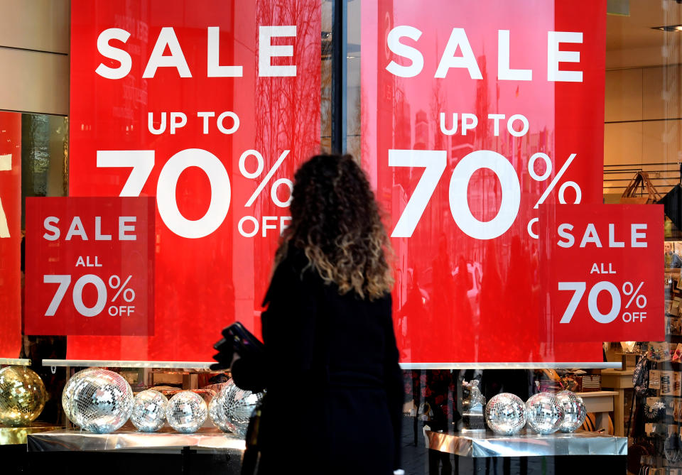 A woman passes sale signs in a shop window in downtown Hamburg, Germany, January 25, 2018. REUTERS/Fabian Bimmer