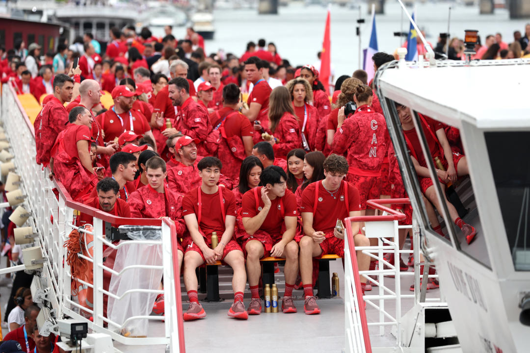 PARIS, FRANCE - JULY 26: Athletes of Team Canada look on from a boat prior to the opening ceremony of the Olympic Games Paris 2024 on July 26, 2024 in Paris, France. (Photo by Hannah Peters/Getty Images)