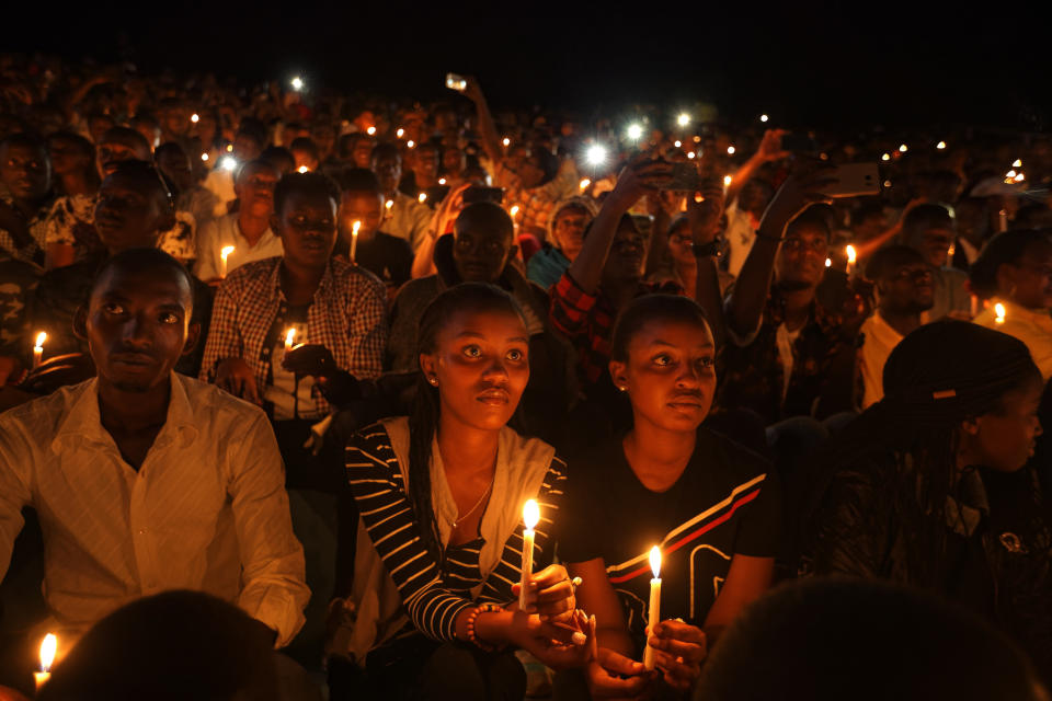 FILE - In this Sunday, April 7, 2019 file photo, people attend a candlelit vigil during a memorial service marking 25 years since the genocide, at Amahoro stadium in the capital Kigali, Rwanda. (AP Photo/Ben Curtis, File)