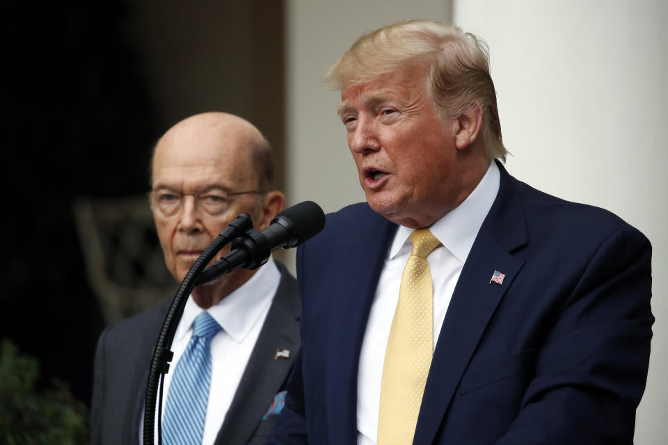 President Donald Trump is joined by Commerce Secretary Wilbur Ross as he speaks in the Rose Garden at the White House in Washington, Thursday, July 11, 2019. (AP Photo/Alex Brandon)