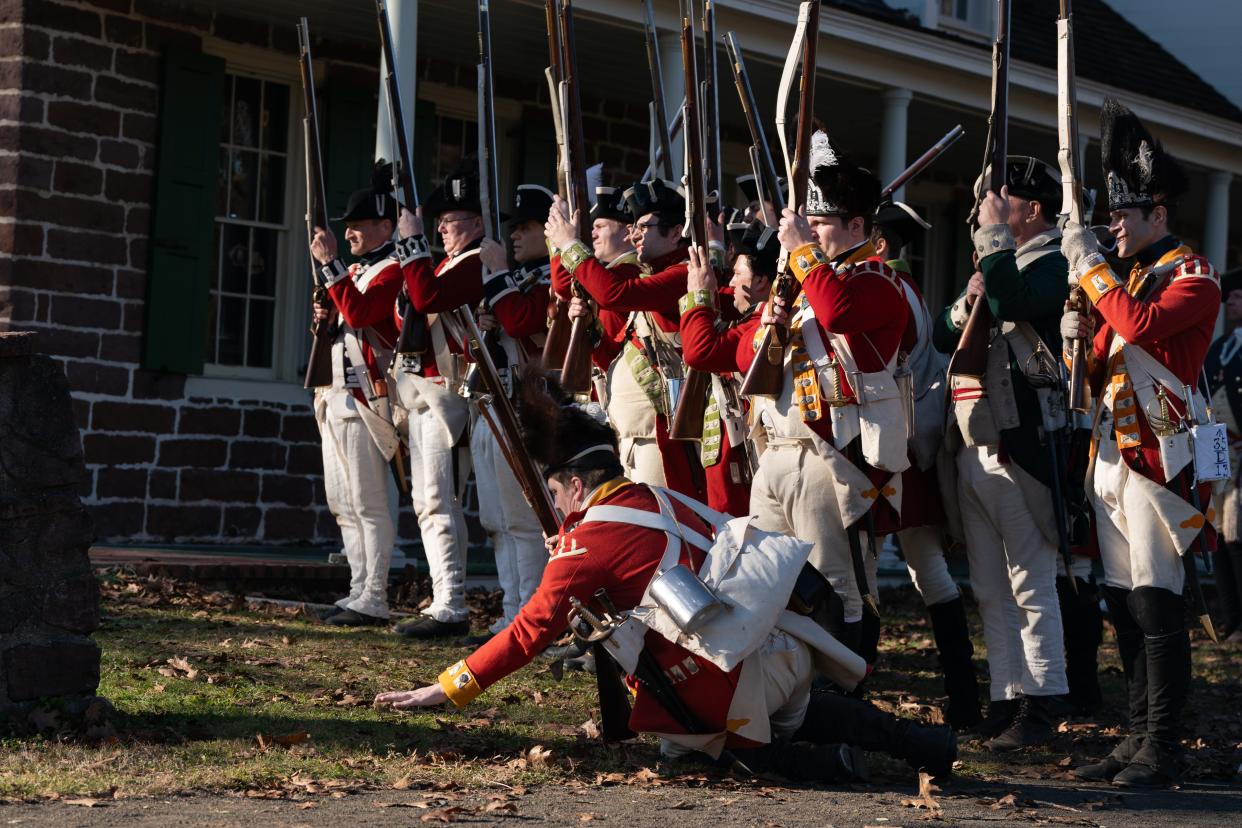 A British soldiers fall to ground after being wounded as part of a Revolutionary War reenactment during Retreat to Victory, Events of November of 1776, at Historic New Bridge Landing in River Edge on Sunday, November 19, 2023. Hosted by the Bergen County Historical Society, participants recreate a battle where General Washington and his army retreat from the British army at New Bridge Landing on November 20, 1776.