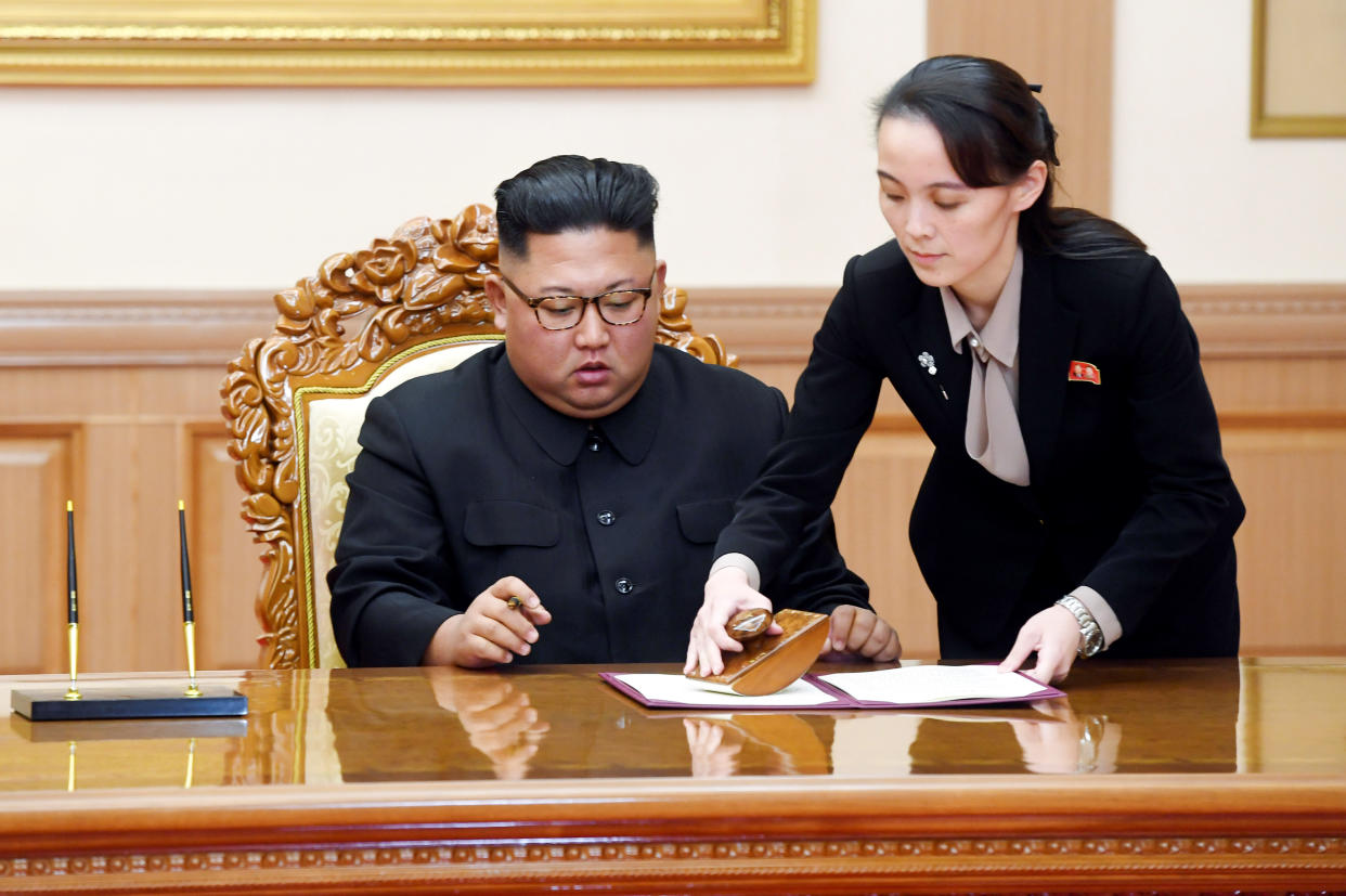 Kim Jong Un signs papers with assistance from younger sister Kim Yo Jong in Pyongyang, North Korea. 