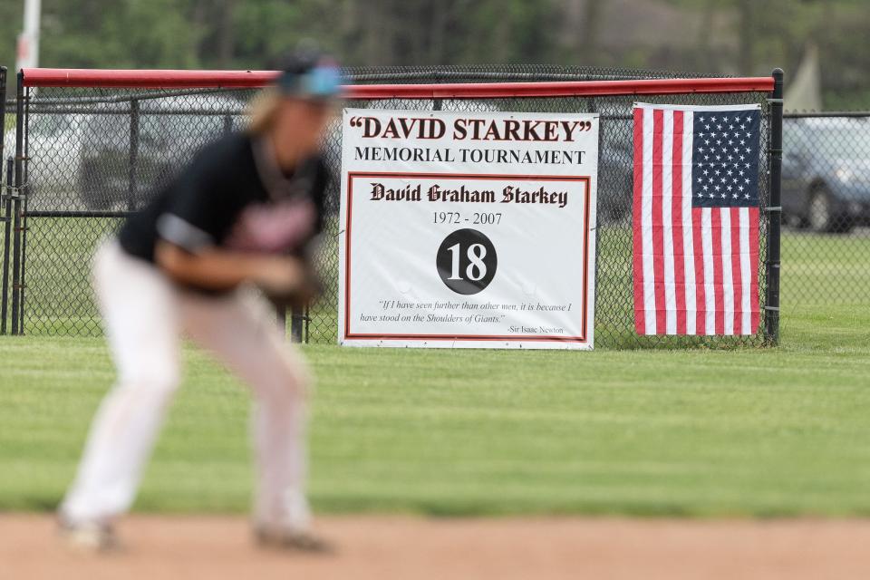 A banner in memory of David Starkey hangs on the outfield wall at Kent Roosevelt High School.