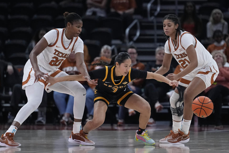 Long Beach State guard Patricia Chung (3) loses control of the ball as she is pressured by Texas forward Khadija Faye (20) and guard Gisella Maul (21) during the second half of an NCAA college basketball game in Austin, Texas, Wednesday, Dec. 6, 2023. (AP Photo/Eric Gay)