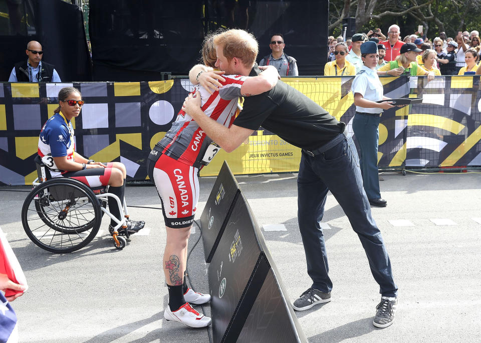<p>Harry shares a hug with the cycling gold medal winner, Canadian Julie Marcotte.</p>