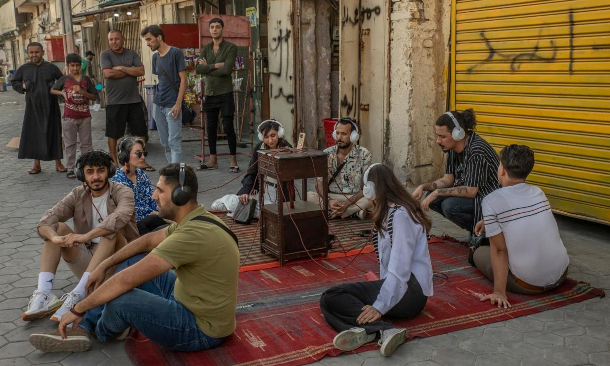 <span>An audience listen to a sound archive by Ateef al-Jaffal during the 2023 festival.</span><span>Photograph: Alessio Mamo</span>