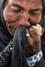 <p>A displaced Iraqi woman wipes away tears at the Hasan Sham camp for Internally Displaced People on June 10, 2017. (Photo: Mohaned El-Shahed/AFP/Getty Images) </p>