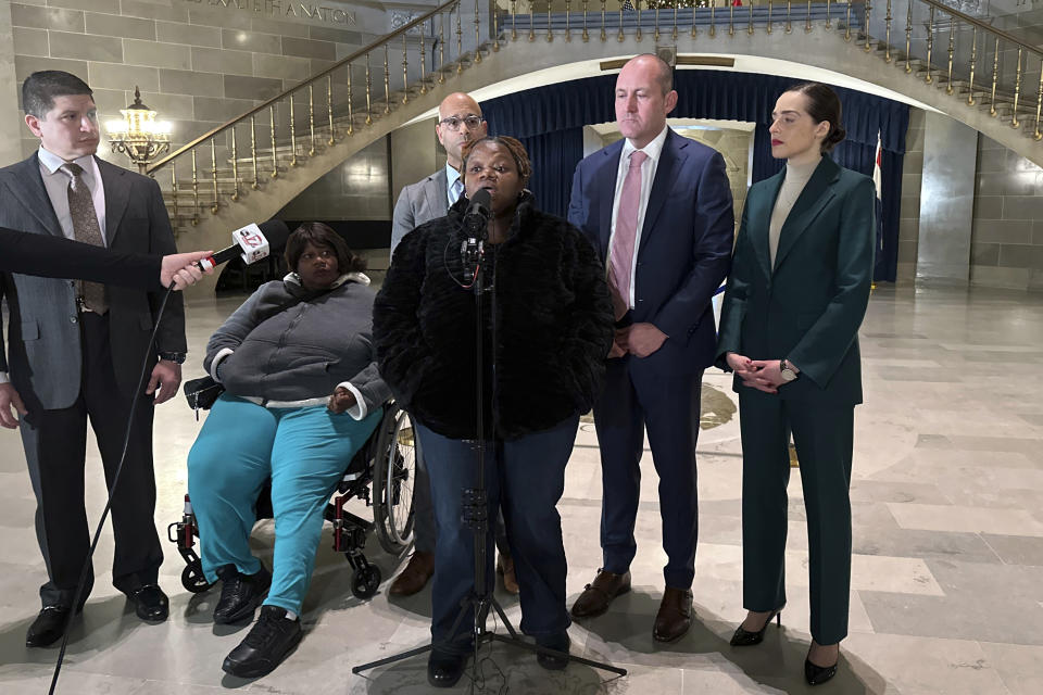 Oriel Moore describes life without her brother, 38-year-old Othel Moore Jr., to reporters, Tuesday, Dec. 19, 2023, at the Missouri Capitol building in Jefferson City, Mo. Four Missouri prison guards have been charged with murder, and a fifth with involuntary manslaughter, in his December 2023 death while he was in custody at the Jefferson City Correctional Center. (AP Photo/Summer Ballentine)