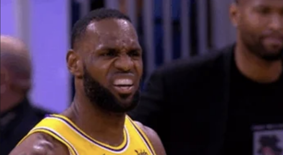 LeBron James, in a jersey, appears to be wincing during a game