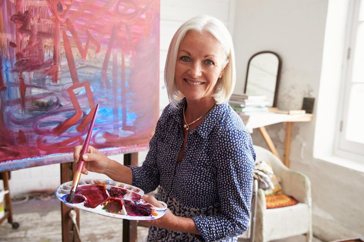 female artist working on painting in studio