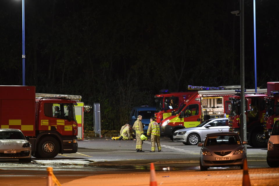 Emergency personnel stand outside the King Power Stadium in Leicester, England after a helicopter belonging to Leicester City Football Club owner Vichai Srivaddhanaprabha crashed in a parking lot. (Joe Giddens/PA via AP)