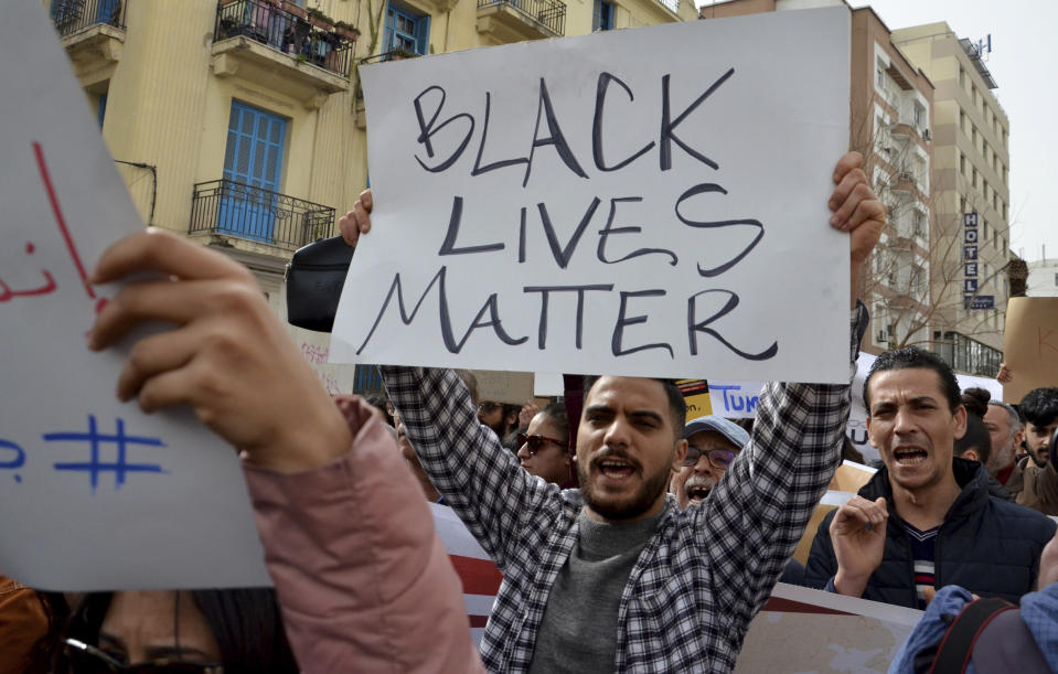 People demonstrate against Tunisian President Kais Saied's comment on migration, Saturday, Feb. 25, 2023 in Tunis. President Kais Saied said Tuesday that "urgent measures" were needed to address the entry of irregular immigrants from sub-Saharan countries, "with their lot of violence, crimes and unacceptable practices." Saied's comments at a National Security Council meeting raised a storm on social media and condemnations from nongovernmental organizations. (AP Photo/ Hassene Dridi)