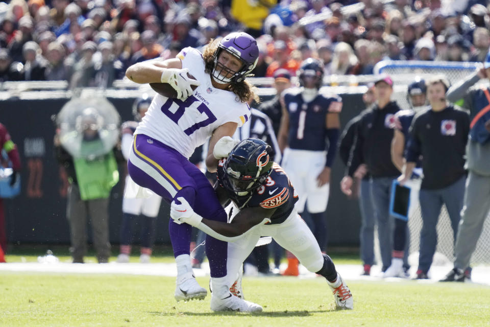 Minnesota Vikings tight end T.J. Hockenson (87) is tackled by Chicago Bears linebacker T.J. Edwards (53) after a pass reception during the first half of an NFL football game, Sunday, Oct. 15, 2023, in Chicago. (AP Photo/Nam Y. Huh)