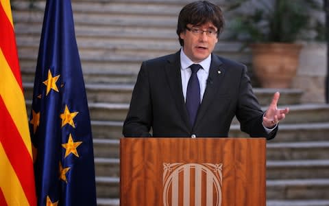 Catalan President Carles Puigdemont speaks during a statement at the Palau Generalitat today - Credit: Presidency Press Service, Pool Photo via AP