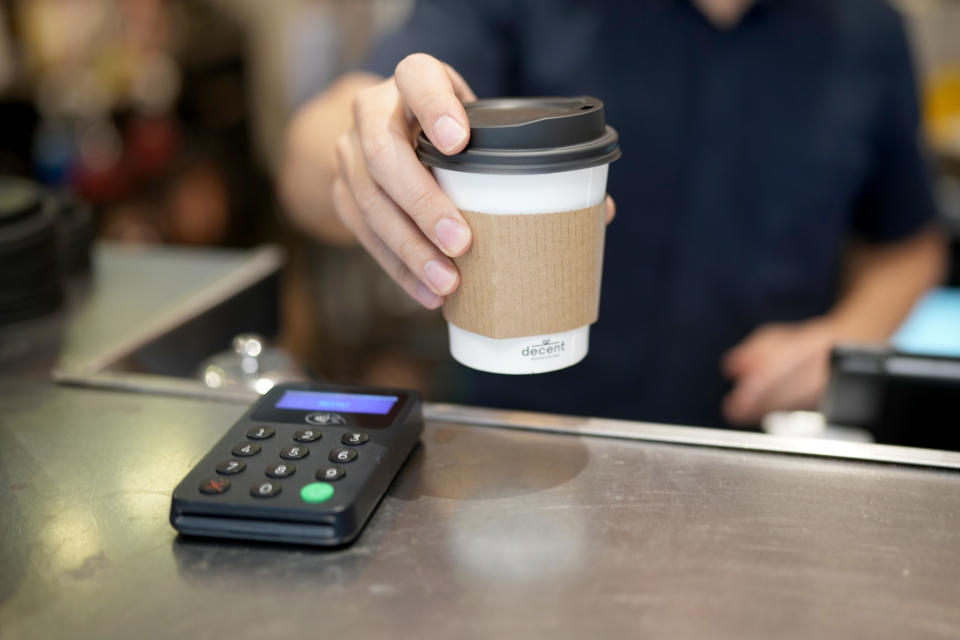 MANCHESTER, UNITED KINGDOM - SEPTEMBER 10: A barista serves a take away coffee on September 10, 2021 in Manchester, United Kingdom. Hospitality sector businesses across England are recovering from the twin disruptions of Covid-19 and Brexit. (Photo by Christopher Furlong/Getty Images)