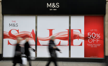 Shoppers walk past sale signs at a branch of the British clothing and food retailer Marks and Spencer on Oxford Street in London, Britain, January 3, 2019. REUTERS/Toby Melville