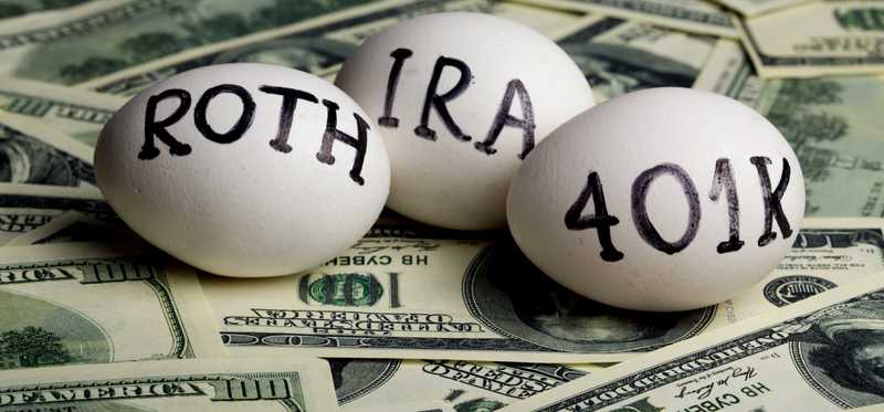 Eggs with IRA, 401K, Roth written on them laying on a pile of cash..