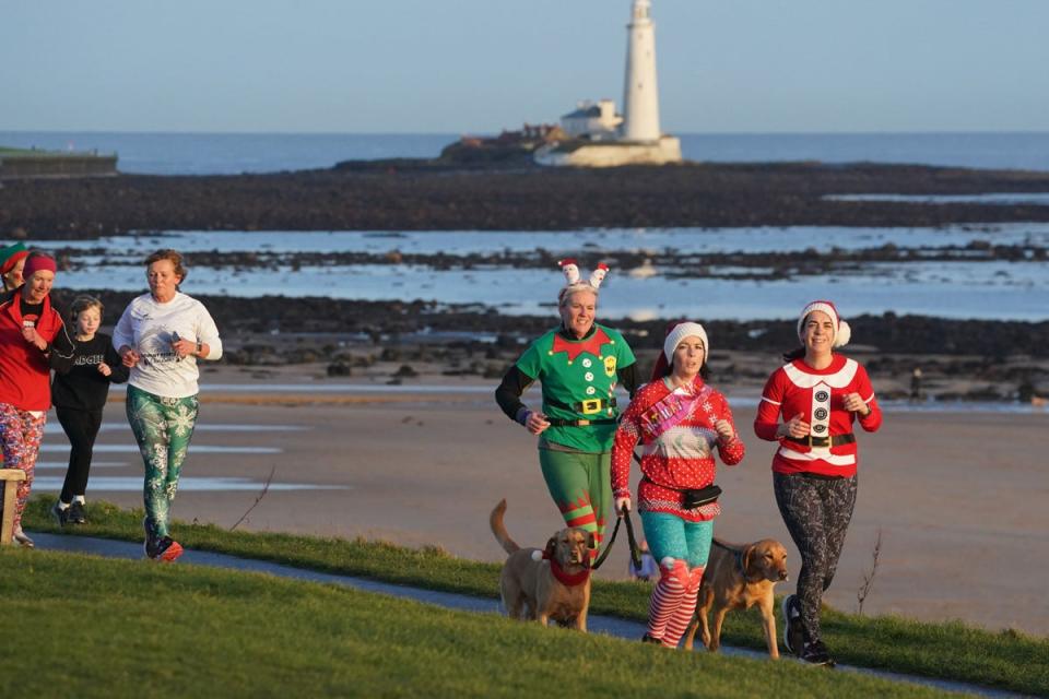 Runners take part in the Christmas Eve park run at Whitley Bay (Owen Humphreys/PA)