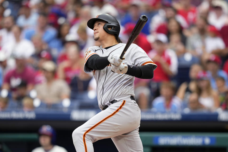 San Francisco Giants' Wilmer Flores watches after hitting a home run against Philadelphia Phillies pitcher Michael Lorenzen during the first inning of a baseball game, Wednesday, Aug. 23, 2023, in Philadelphia. (AP Photo/Matt Slocum)