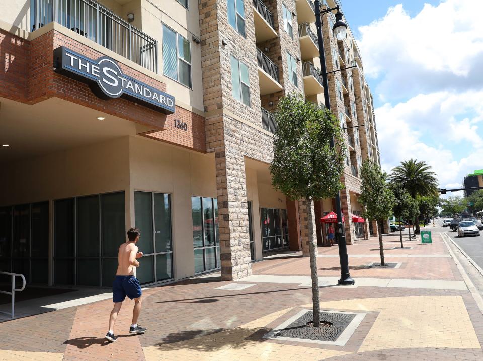 A jogger makes his way down the sidewalk in front of The Standard apartment complex.