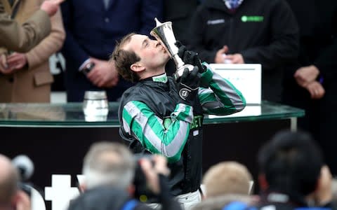 Jockey Nico de Boinville kisses the trophy after winning the Betway Queen Mother Champion Chase - Credit:  Andrew Matthews/PA Wire