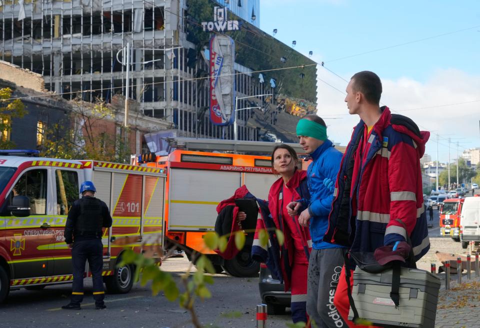 An injured man receives medical treatment at the scene of Russian shelling, in the Shevchenko district of Kyiv (AP)