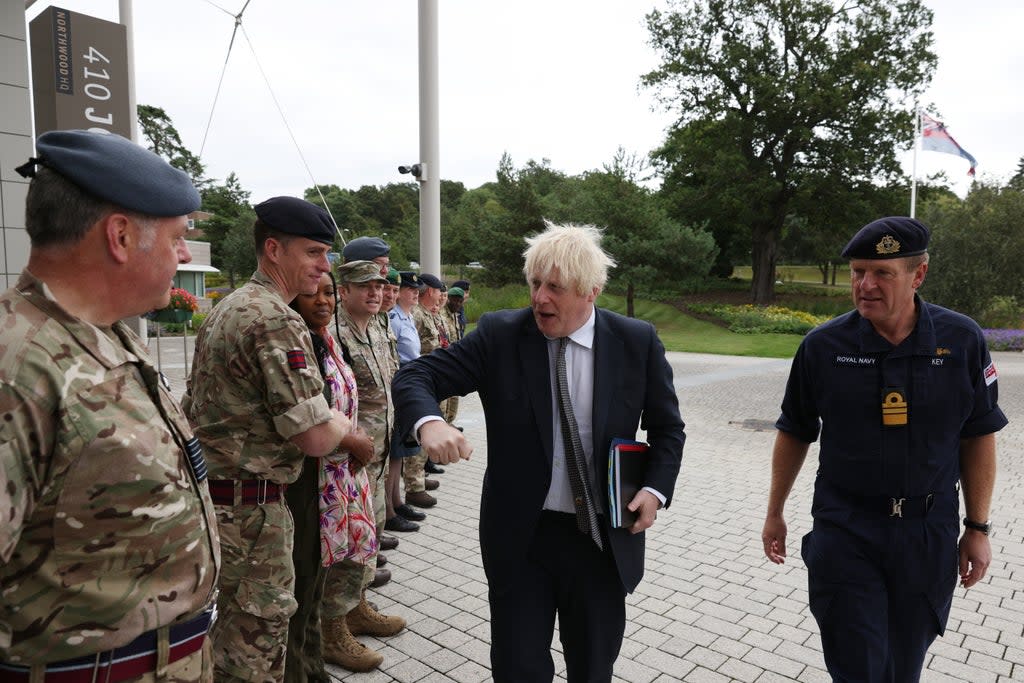 Prime Minister Boris Johnson walks with Vice Admiral Ben Key (right) as he greets military personnel  ((Adrian Dennis/PA))