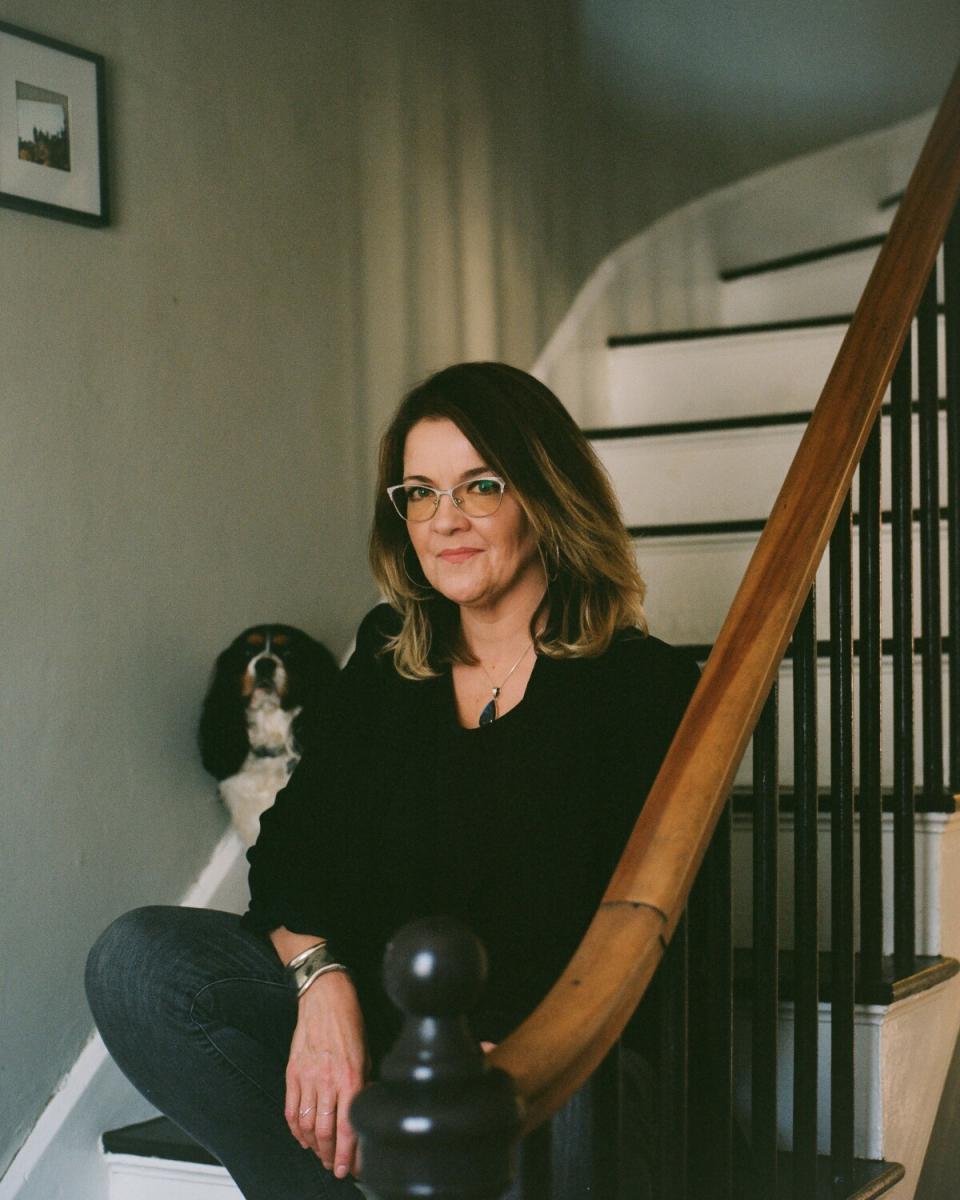 Amy Roeder, 48, sits for a portrait with her dog, Senator Theodore S. Pumkins, at her home in Bangor, Maine.