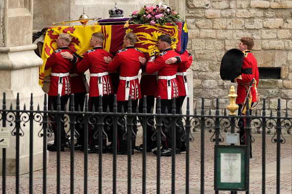 LONDON, ENGLAND - SEPTEMBER 19: The coffin of Queen Elizabeth II with the Imperial State Crown resting on top is carried by the Bearer Party into Westminster Abbey during the State Funeral of Queen Elizabeth II on September 19, 2022 in London, England. Elizabeth Alexandra Mary Windsor was born in Bruton Street, Mayfair, London on 21 April 1926. She married Prince Philip in 1947 and ascended the throne of the United Kingdom and Commonwealth on 6 February 1952 after the death of her Father, King George VI. Queen Elizabeth II died at Balmoral Castle in Scotland on September 8, 2022, and is succeeded by her eldest son, King Charles III.  (Photo by Christopher Furlong/Getty Images)