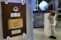 A boy looks a screen showing the moon next of a tiny piece of moon rock encased in a plastic globe on display at the an exhibition commemorating the 50th anniversary of the last of the U.S. manned missions to the moon and the Artemis spacecraft now orbiting the moon, in Nicosia, Cyprus, Thursday, Dec. 8, 2022. A half century after U.S. astronauts brought it back from the moon's surface, this tiny piece of cosmic rock has finally reached its intended destination, the east Mediterranean island nation of Cyprus. (AP Photo/Petros Karadjias)
