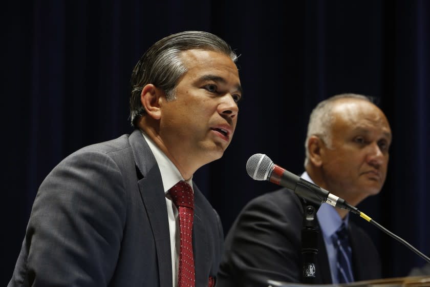 LOS ANGELES, CA - Dec. 1, 2015: State legislators including California State Assembly member Rob Bonta, left, and Sen. Ed Hernandez, right, discuss a tax to fund Medi-Cal during an informational hearing titled "Managed Care Organization Tax Overview," held in the auditorium of the Ronald Reagan State Building in Los Angeles. Way more people signed up for Medi-Cal than anyone expected, and now the state is paying $18 billion for the program - more than 10% of the state's total budget. Those costs are only going to climb in the coming years. (Photo by Katie Falkenberg / Los Angeles Times)