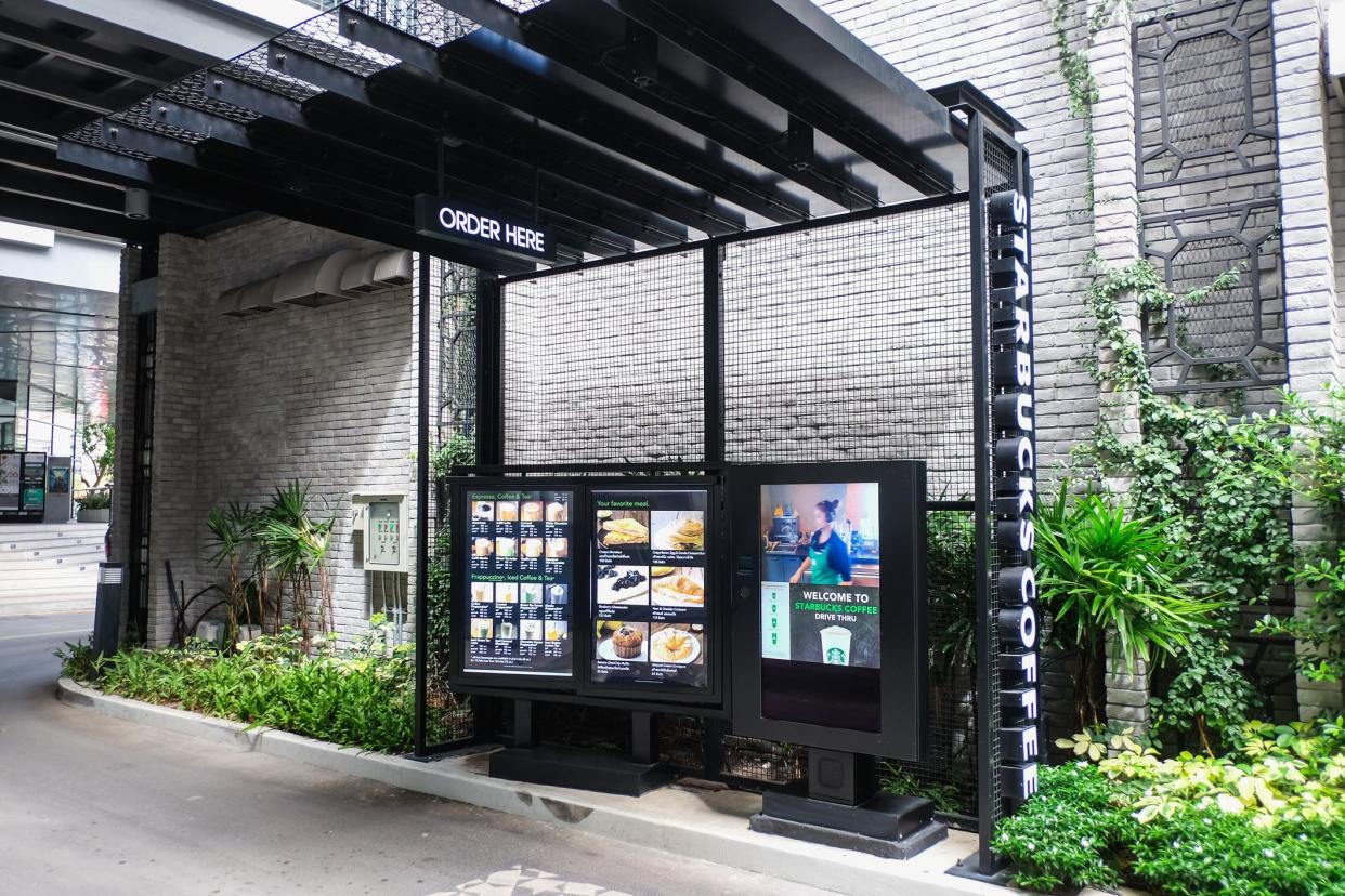 Bangkok, Thailand - June 14 , 2017: Starbucks Drive Thru at JAS URBAN Srinakarin community mall, Starbucks is a global coffee chain, Customer in BMW car order coffee from Starbucks drive thru service