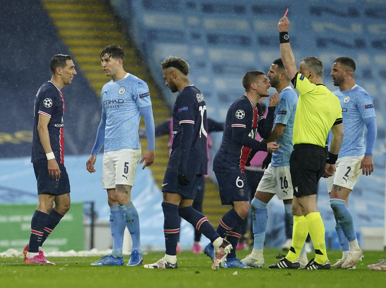 PSG's Angel Di Maria, left, sees a red card during the Champions League semifinal second leg soccer match between Manchester City and Paris Saint Germain at the Etihad stadium, in Manchester, Tuesday, May 4, 2021. (AP Photo/Dave Thompson)