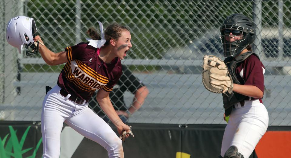 Walsh Jesuit's Sienna Tepley, left, celebrates after scoring a run as Boardman catcher Madison Wymer looks on during the first inning of the Warriors' 2-1 win in a Division I district final in Massillon on Thursday.