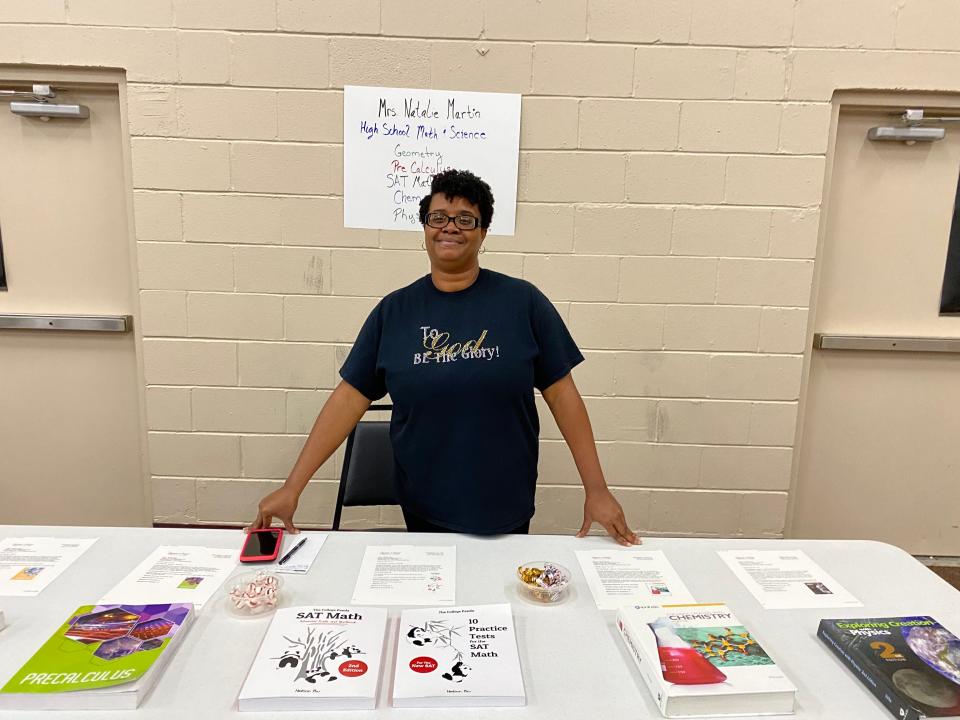 Natalie Martin, high school math and science teacher at the Space Coast Christian Co-op, displays learning materials at a May 25 open house for interested families