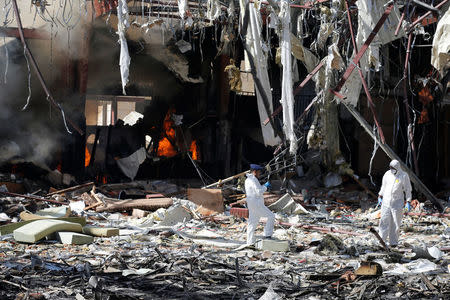 Forensic experts investigate the scene at the community hall where Saudi-led warplanes struck a funeral in Sanaa, the capital of Yemen, October 9, 2016. REUTERS/Khaled Abdullah