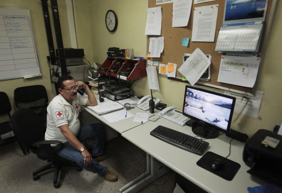 A member of El Salvador's Red Cross talks on the phone after a magnitude 7.3 earthquake struck late on Monday, at a Red Cross office in San Salvador October 13, 2014. (REUTERS/Oswaldo Rivas)