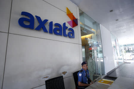 A security officer guards in front of the Axiata headquarters buiding in Kuala Lumpur May 28, 2014. REUTERS/Samsul Said/Files