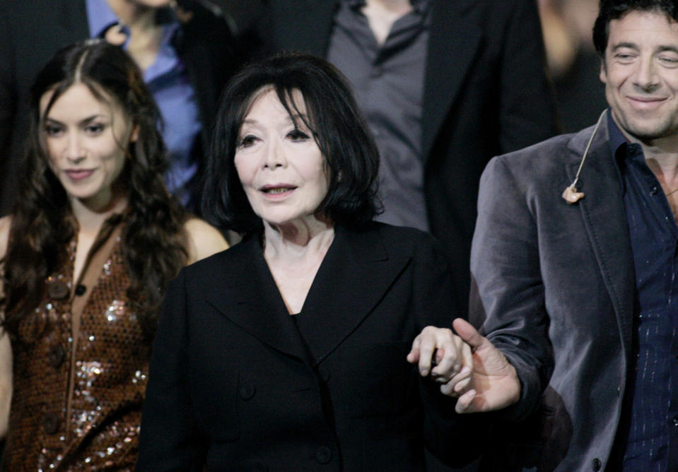 FILE - In this Saturday, March 10, 2007 file photo, French singer Juliette Greco, center, with pop singer Olivia Ruiz, left, and singer Patrick Bruel receives French award of Honor during the Victoires de la Musique, in Paris. French media say Juliette Greco, singer, actress, cultural icon and muse to Existentialist philosophers of France’s post-War period, has died aged 93. They said Wednesday, Sept. 23, 2020 Greco died in her Ramatouelle house in the south of France, near Saint Tropez. (AP Photo/Jacques Brinon, file)