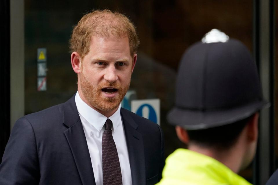 Prince Harry leaves the High Court after giving evidence in London (AP)