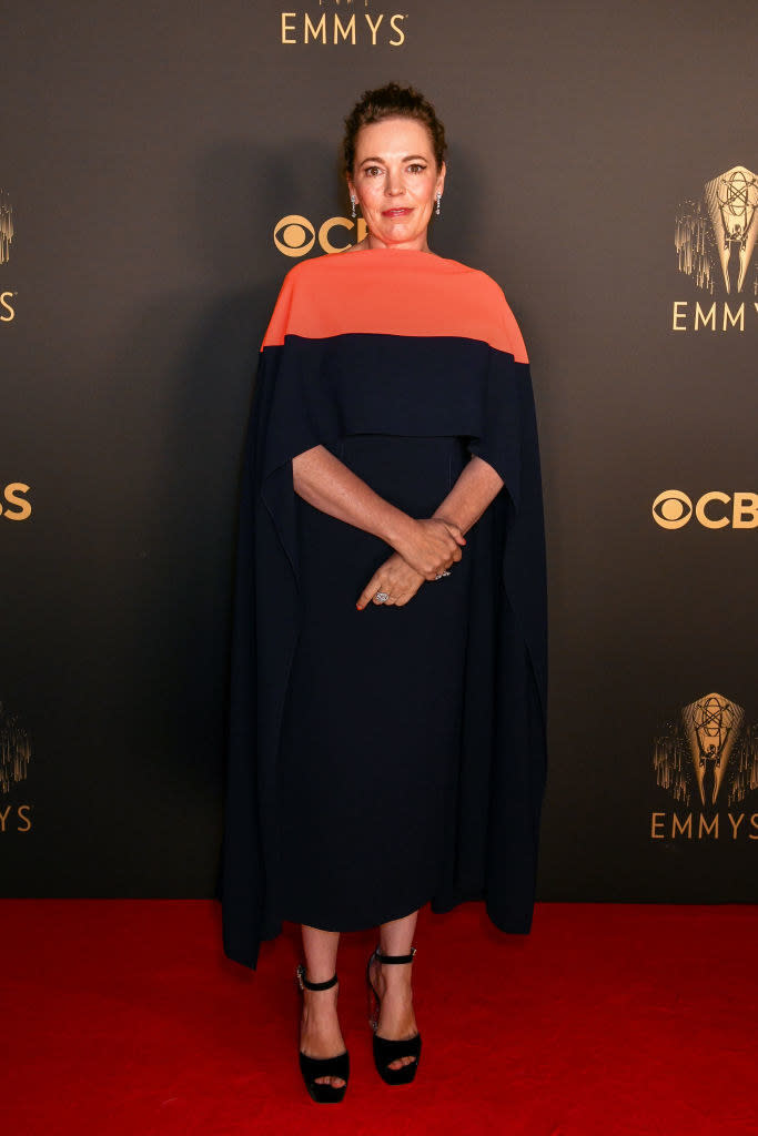 Olivia Colman on the red carpet in a navy and orange dress