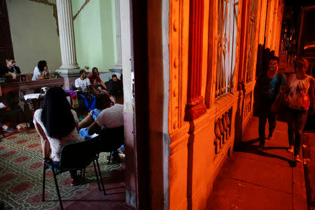 Worshippers and activists supporting the lesbian, gay, bisexual and transgender community (LGBT), attend a service at the Metropolitan Community Church (MCC) in Matanzas, Cuba, October 12, 2018. REUTERS/Alexandre Meneghini