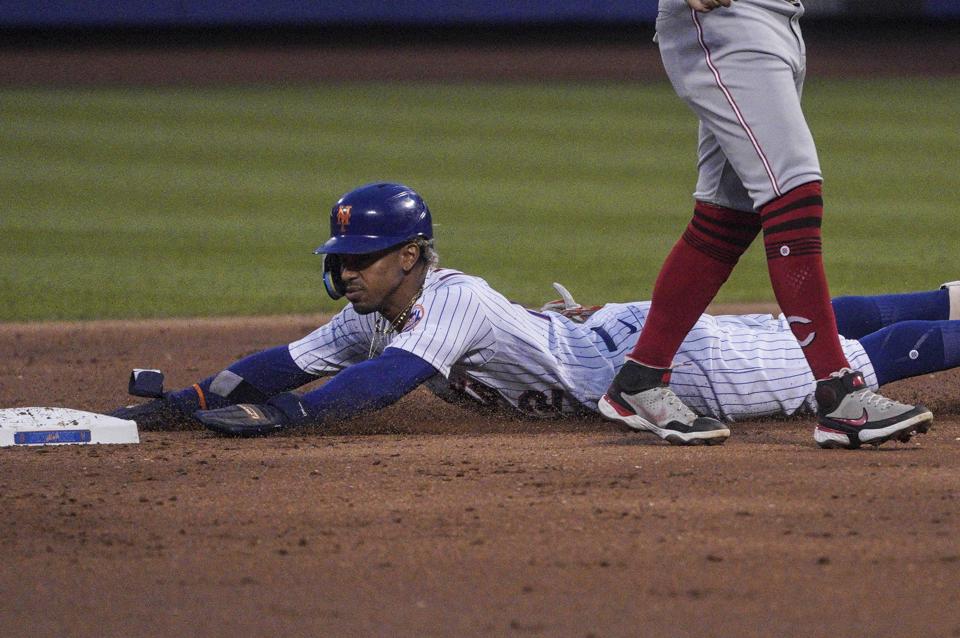 New York Mets' Francisco Lindor slides safely into second base during the third inning of a baseball game against the Cincinnati Reds, Monday, Aug. 8, 2022, in New York. (AP Photo/Bebeto Matthews)