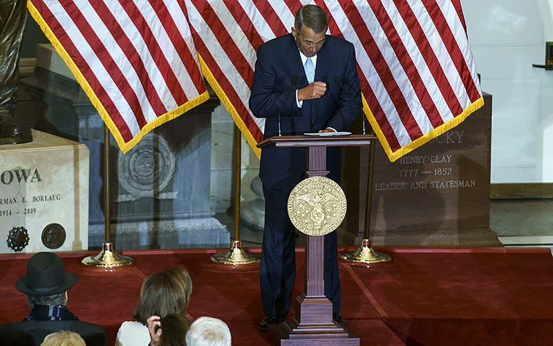 Former House Speaker John Boehner (R-Ohio) gets emotional as he speaks during a ceremony in Statuary Hall to unveil a portrait of Speaker Nancy Pelosi (D-Calif.) on Dec. 14. <em>Greg Nash</em>