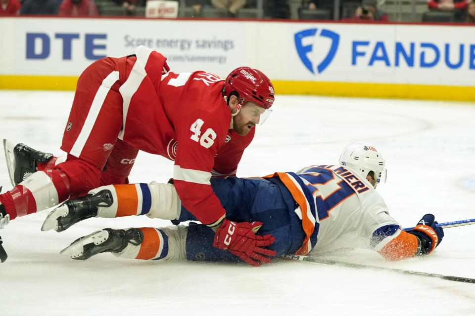 Detroit Red Wings defenseman Jeff Petry (46) checks New York Islanders center Kyle Palmieri (21) during the first period of an NHL hockey game, Thursday, Feb. 29, 2024, in Detroit. (AP Photo/Carlos Osorio)