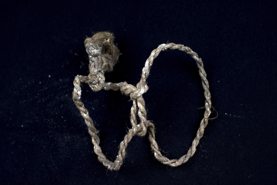 In this Thursday, March 26, 2019 photo, a rope found tied at the wrists of a human skeleton and photographed after being exhumed from a mass grave at the cemetery of Paterna, near Valencia, Spain, as archaeologists conduct forensic analysis of the remains. DNA tests will be conducted in the hope of confirming the identities of those who disappeared eight decades ago, believed to have been executed by the forces of Gen. Francisco Franco during and after the 1936-39 Spanish Civil War. (AP Photo/Emilio Morenatti)