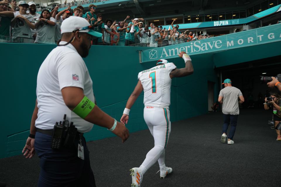 Miami Dolphins quarterback Tua Tagovailoa (1) raises his fist in the air as fans cheer after a victory against the Denver Broncos following an NFL game at Hard Rock Stadium in Miami Gardens, Sept. 24, 2023.