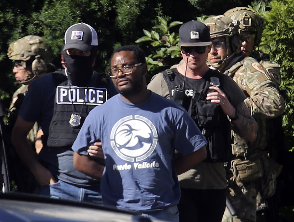 FILE - In this June 28, 2019, file photo, Salt Lake City police take Ayoola A. Ajayi into custody in connection with missing University of Utah student MacKenzie Lueck in Salt Lake City. Ajayi, has been charged with murder, kidnapping and other charges in the death of Lueck. Prosecutors filed the case Wednesday, July 10. District Attorney Sim Gill also said Lueck's cause of death was blunt force trauma to the head, and her body was found with her arms bound behind her. (Kristin Murphy/The Deseret News via AP, File) MANDATORY CREDIT TV OUT