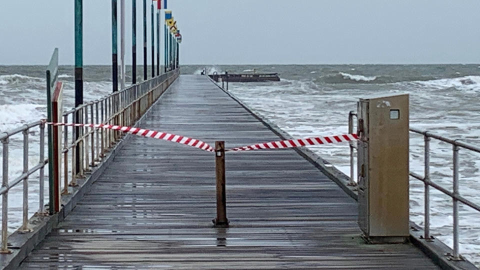 Photo shows tape sectioning off the pier which snapped off due to harsh weather conditions.